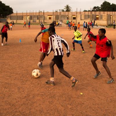 A Projects Abroad volunteer work with teens to teach football in Ghana. A sports player gains experience through volunteer football coaching in Ghana.